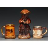 A Victorian treacle brown glazed snuff taker Toby jug and cover, 26cm h, a silver mounted Doulton