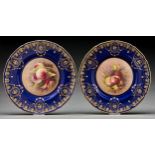 A pair of Royal Doulton bone china plates, 1929-1931, painted by G Evans, both signed, with fruit