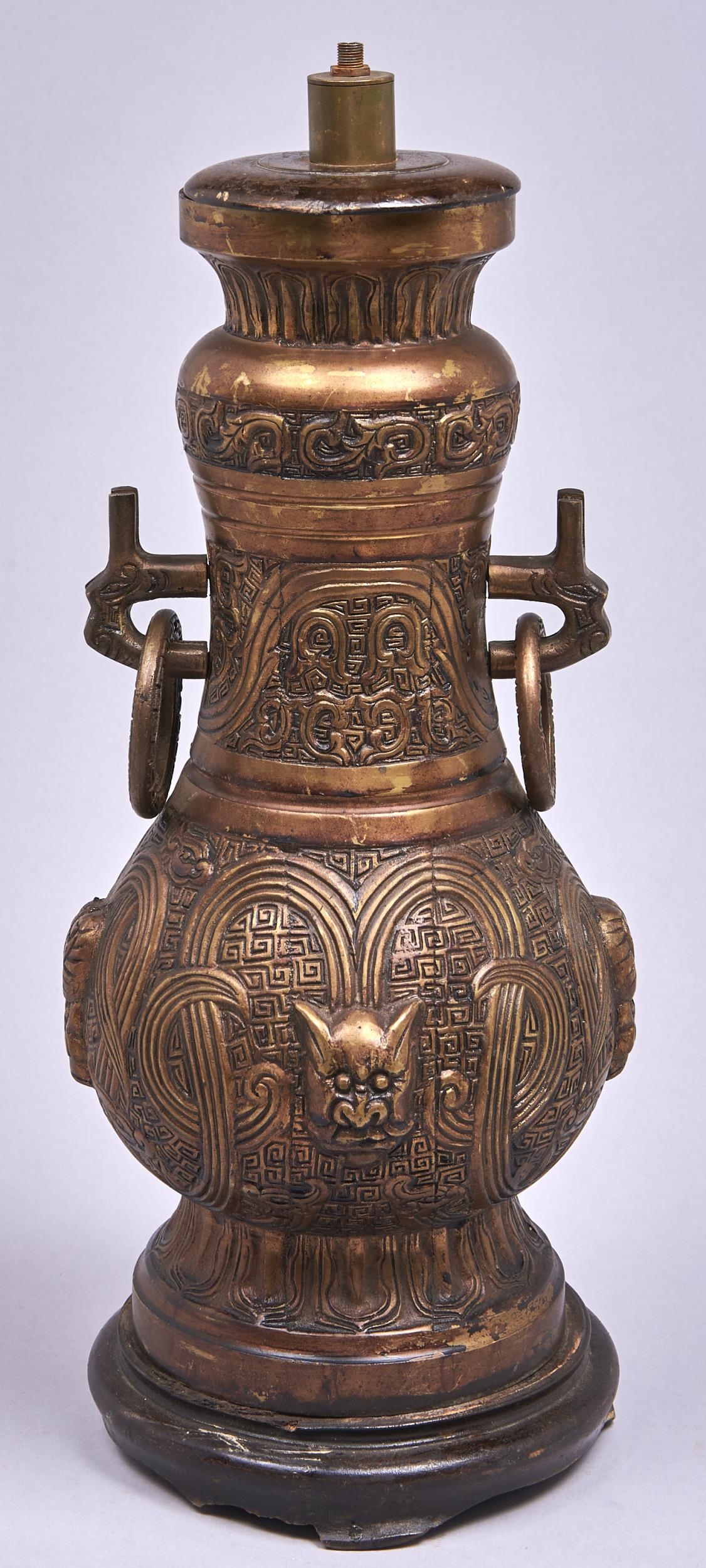 A gilt lacquered brass lamp, in archaic Chinese style, wood base, 47cm h Patina scratched and dirty