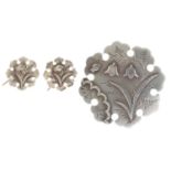 A Victorian silver brooch and pair of earrings en suite, with applied floral decoration, brooch