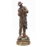 A French bronze statuette of a gardener lighting his pipe, c1900, cast from a model by Maurice