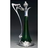 A WMF Jugendstil pewter mounted green glass claret jug and stopper, c1910, with whiplash handle,