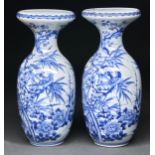 A pair of Japanese blue and white vases, Meiji period, painted with a bird in a cherry tree,