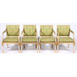 A set of four Scandinavian painted and gilt open armchairs, 19th c, the padded back, seat and arms