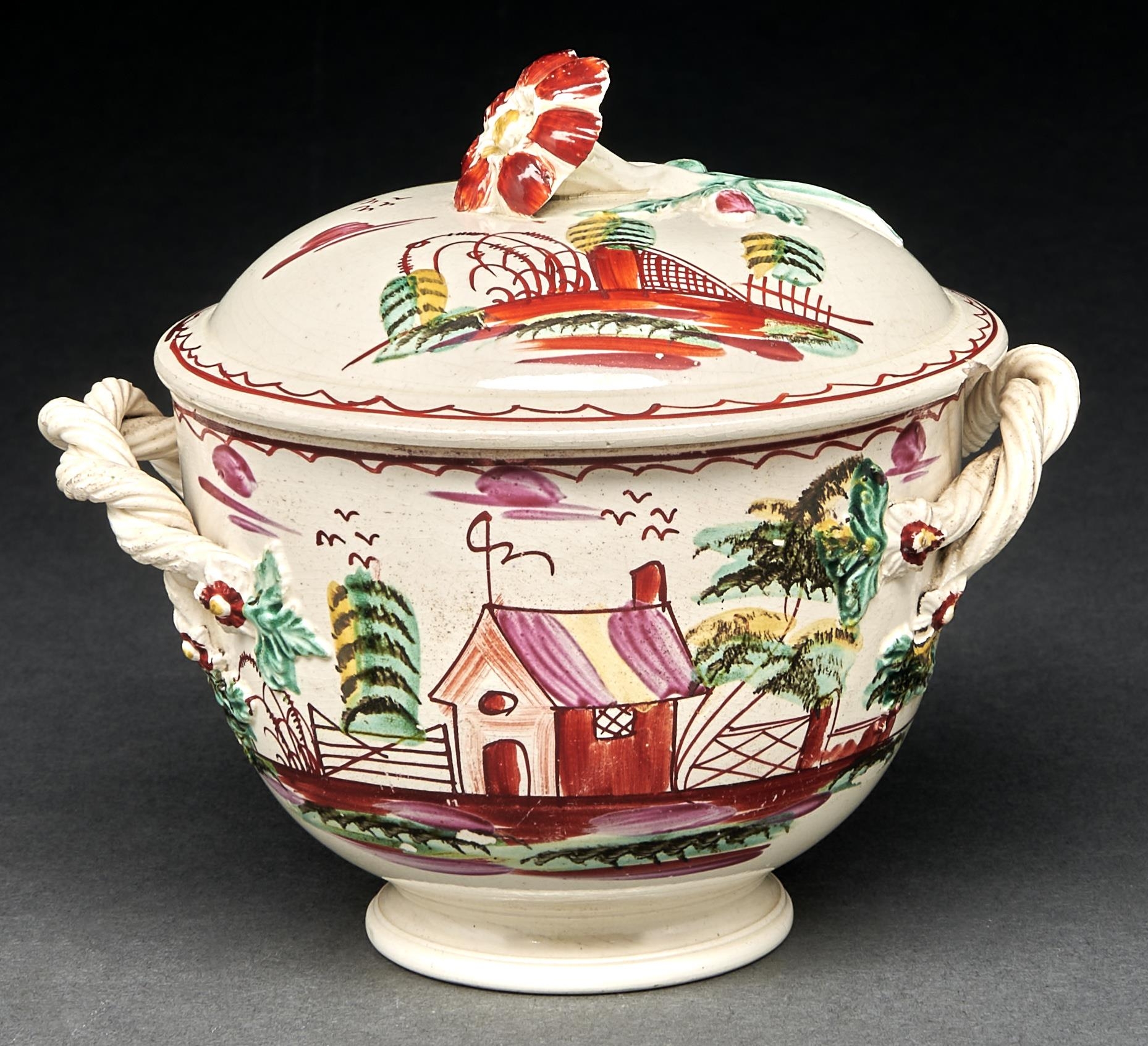 An English creamware sucrier and cover, c1780-90, with entwined handles and flower knop, brightly