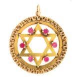 An Israeli synthetic ruby and gold openwork Star of David pendant, 30mm diam, marked 14k, 5.1g