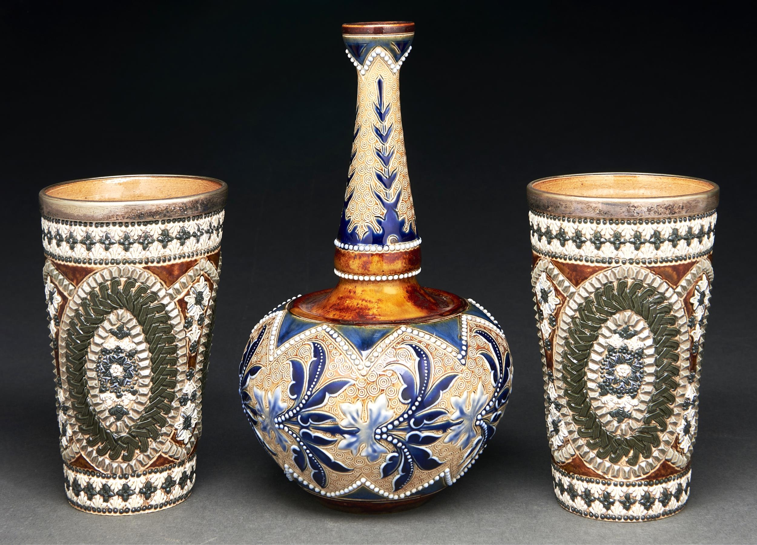 A pair of EPNS mounted Doulton ware water or lemonade beakers, 1881, decorated by Jane S Hurst