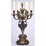 A patinated and lacquered brass candelabrum of six lights, c1900, with flambeau finial, 74cm h