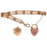 A gold bracelet and padlock, marked 9c, 17cm l and a 9ct gold heart locket, 18.2g (2) Dent on