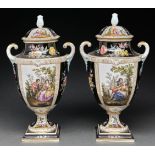 A pair of German porcelain shield shaped vases and covers, early 20th c, painted with scenes of 18th