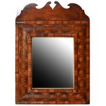 A William III oyster olive wood cushion moulded mirror, c1700, 69 x 49cm The walnut cresting an