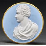 A Continental white and pale blue biscuit porcelain cameo of Lord Byron, rim gilt, 85mm Good