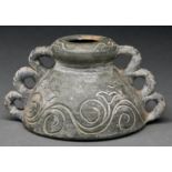 A South East Asian pottery vessel, of domed shape, incised with running scrolls between triple