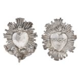 Two  silver repousse ex voto heart plaques, 19th c,   one with the crown of thorns the other with