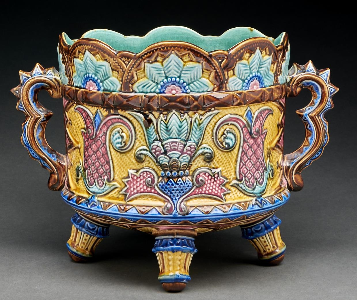 A majolica jardiniere, c1880, the sides moulded with a band of stylised pineapples and foliage on