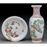 A Chinese famille rose peaches and bats dish, 22cm diam, Yongzheng mark and a famille rose peacock