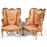 A pair of French giltwood armchairs, fauteuils a l'oreilles, c1900, in Louis XV style, crisply