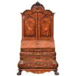 A Dutch walnut and marquetry bureau-cabinet, 19th c, with carved, arch centred pediment and leafy