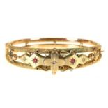 An Edwardian ruby and diamond bangle, in 9ct gold, gypsy set, part marked and applied Rd No, 10.2g
