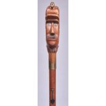 A carved wood  cane, the handle in the form of the head of a miner, with glass eyes and brass