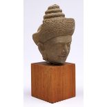 A Khamer style stone head of Vishnu, Cambodia, on wood block, 35cm h Good condition, no