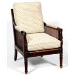 A Regency mahogany and caned bergere, early 19th c, with reeded frame, padded arms, seat height 33cm