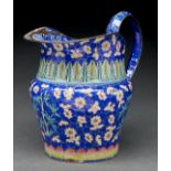 A Canton painted enamel jug, 19th c, decorated in two registers with blossom and bamboo on a blue