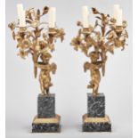 A pair of French gilt bronze candelabra, early 20th c, in Louis XVI style, as Putto with flowers