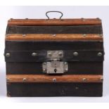 A black painted cloth covered and brass studded wood doll's travelling trunk, early 20th c, with