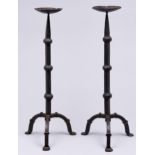 A pair of wrought iron pricket candlesticks, 20th c, the knopped square tapered pillar on three