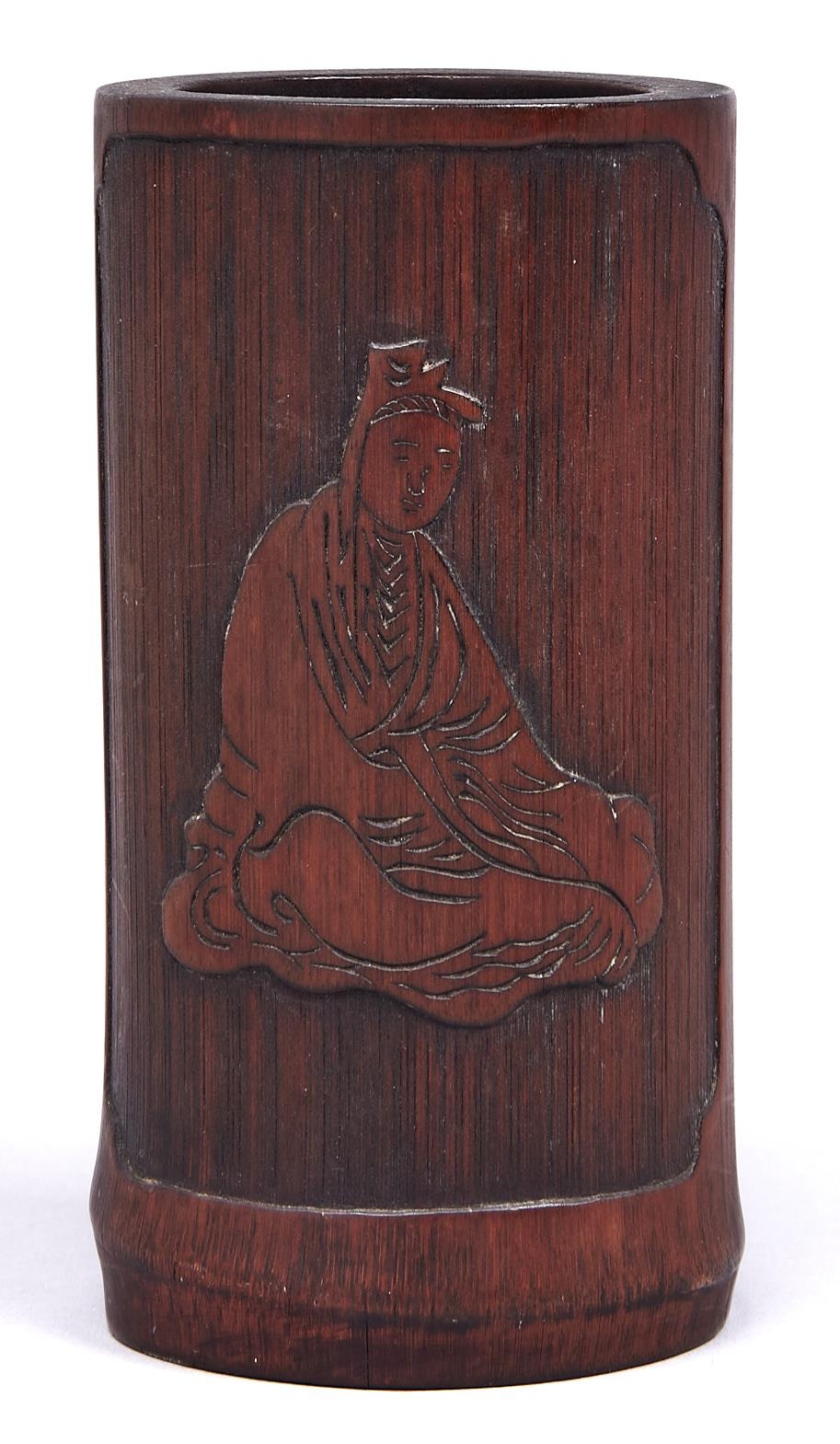 A Chinese bamboo brush pot, carved in shallow relief with a seated figure, the reverse incised