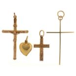 A 9ct gold crucifix and two crosses, various sizes and a gold heart pendant marked 9ct, 9.2g