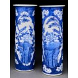 A pair of Chinese blue and white cylindrical vases, Qing dynasty, late 19th c, painted with two