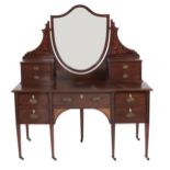 An Edwardian mahogany and inlaid dressing table, with shield shaped mirror, 184cm h; 55 x 153cm