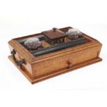 An early Victorian bronze mounted oak and ebony inkstand, attributed to Gillows, of sarcophagus