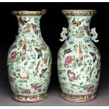 A pair of Chinese Canton famille rose celadon ground vases, mid 19th c, enamelled with colourful