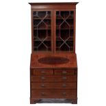 An Edwardian mahogany bureau-cabinet, crossbanded in rosewood and line inlaid, fitted with