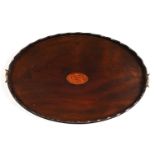 A George III oval mahogany tea tray, the undulating gallery of laminated construction, 78cm l