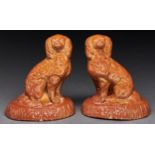 A pair of Derbyshire saltglazed brown stoneware models of spaniels, Chesterfield, second half 19th