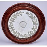 A Victorian glass convex and etched 'witches' mirror, with rose and thistle border, circular oak