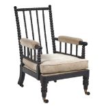 A George IV bobbin turned and ebonised open armchair, with padded arms, brass castors, seat height