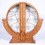 An Art Deco walnut and burr walnut round  cabinet, c1950, the twin vertical ovolo mouldings with