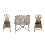 Silver toys. A German  miniature table and pair of chairs, table 50mm, import marked S B Landeck,