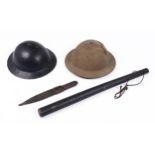 Two WWII steel helmets, a truncheon and an African knife with leather sheath (4) Condition