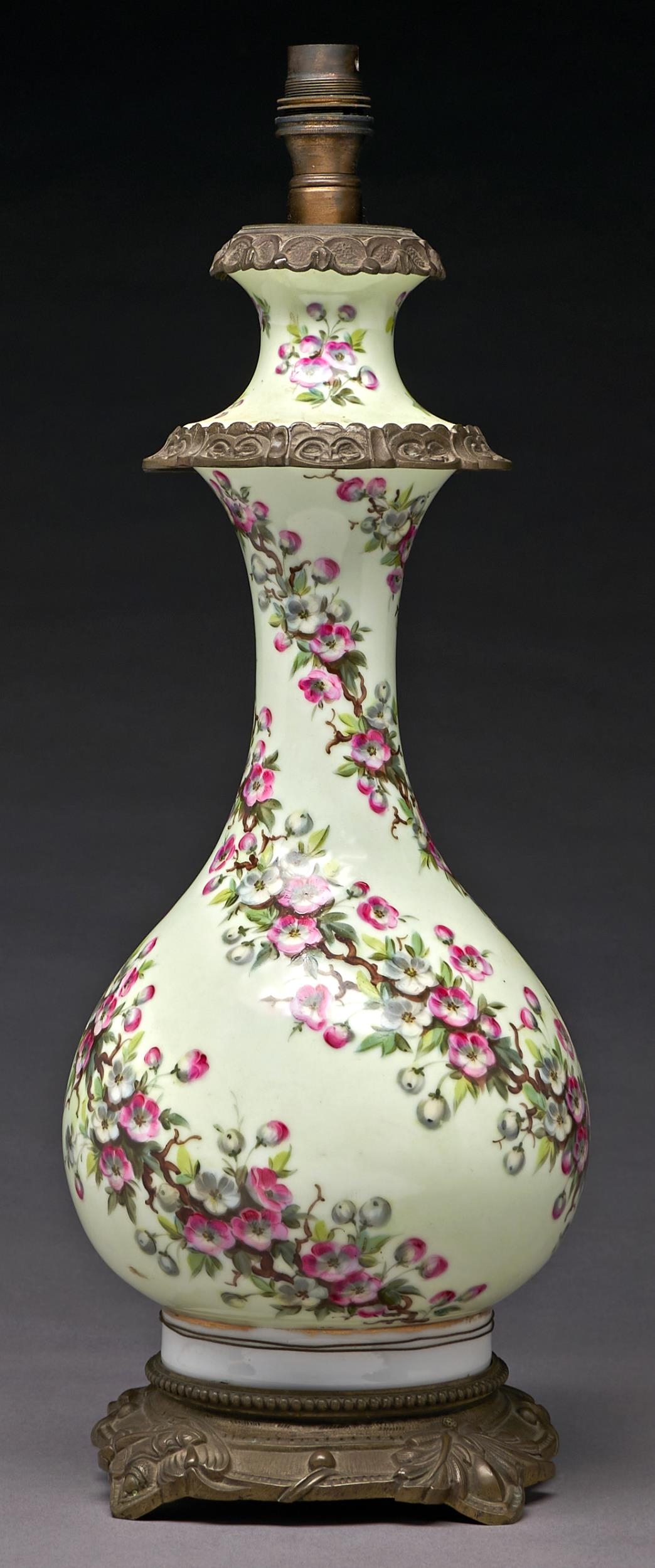 A French gilt lacquered brass mounted porcelain oil lamp, c1880, of baluster shape, painted with