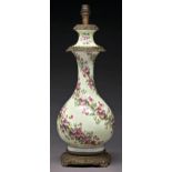 A French gilt lacquered brass mounted porcelain oil lamp, c1880, of baluster shape, painted with