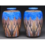 A pair of Clews & Co Chameleon ware vases, 1914-1939, with brown leaves on a mottled blue eggshell