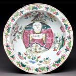 A Chinese Canton famille rose bowl, mid 19th c, painted to the centre with a smiling man holding a