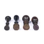 Four hand seals with brass, bronze or steel matrix and turned lignum vitae, laburnum or ebonised
