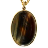 A tiger's eye pendant, in 9ct gold, 25mm, London 1984 and a plated chain Condition ReportGood